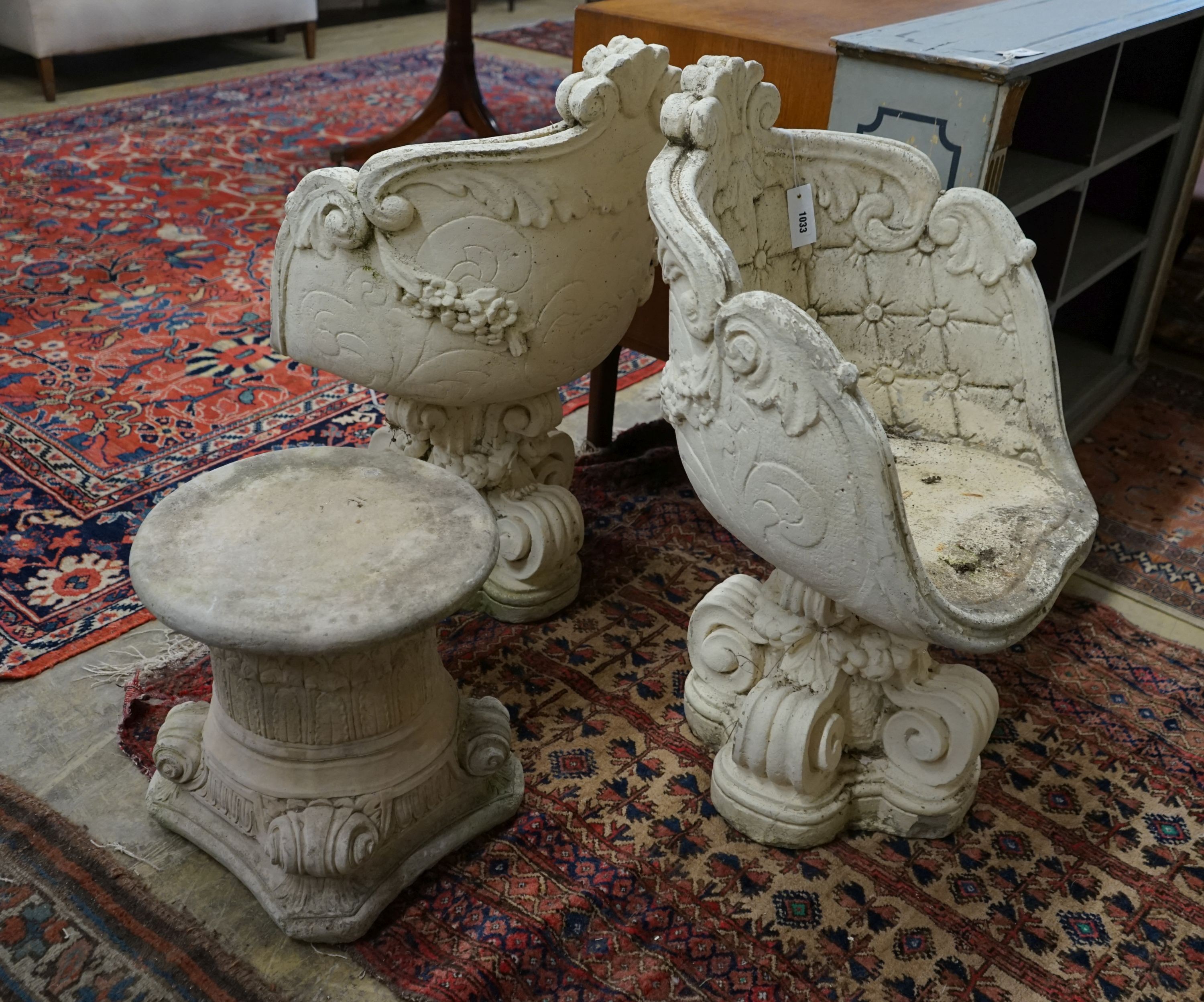 A pair of reconstituted stone tub framed garden chairs, width 55cm, depth 42cm, height 84cm together with a similar low table